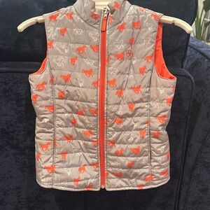 Ariat reversible insulated vest. Child’s Size small.  Orange/ horse pattern